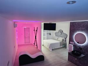 a bedroom with a bed and a purple lighting at Secrets Torrevieja in Torrevieja +13 photos