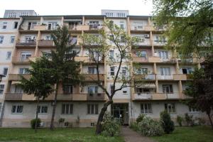 an apartment building with trees in front of it at Dolce Rita Apartman in Budapest