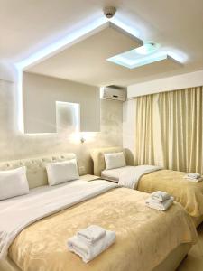 a bedroom with two beds and a large mirror at Hotel Oasis in Podgorica