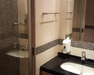 a bathroom with a sink and a shower with a mirror at Select Lux Angella-Konaci in Kopaonik +125 photos