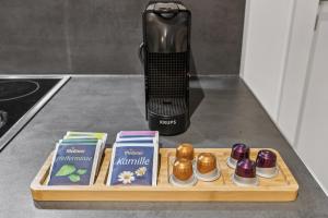 a wooden tray with different types of food on a counter at Arbio I Stylish Apart Schöneberg S-Bahn in Berlin +5 photos