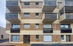 a building with balconies on the side of it at Cozy Apartment In Dunkerque in Dunkerque