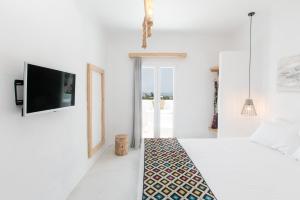 Postel nebo postele na pokoji v ubytování Irida Vacation Suites + 114 fotografií