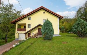 a large yellow house with a large yard at Amazing Apartment In Vrbovsko With Sauna in Vrbovsko