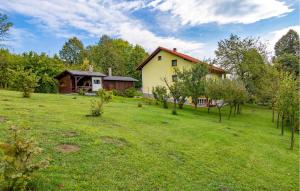 a house in the middle of a field with trees at Amazing Apartment In Vrbovsko With Sauna in Vrbovsko +17 photos