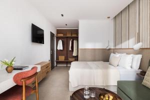 a hotel room with a bed and a living room at Orizon Boutique Rooms in Kalamitsi