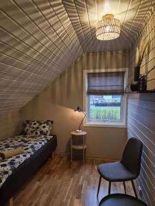a room with a bed and a chair and a window at Trines Hjerterom in Steinkjer +26 photos