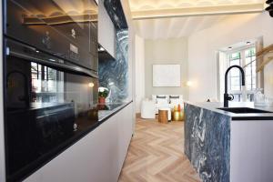 a kitchen with a sink and a stove top oven at Antonia Luxury Home in Seville