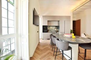 a dining room and kitchen with a table and chairs at Antonia Luxury Home in Seville +11 photos