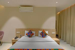 a bedroom with a large bed in a room at FabHotel Blue Moon in Hanamkonda