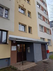 a building with a door in front of it at Piotrków Trybunalski Comfort Apartment by BookingHost in Piotrków Trybunalski