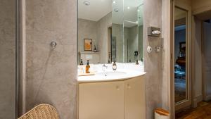 a bathroom with a sink and a shower at Le Prieuré d'Arbois in Arbois