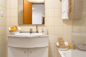 a bathroom with a sink and a mirror at Casa Nóbrega in Caniço +13 photos
