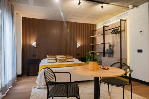 a bedroom with a bed and a table and chairs at BUBU Apartments By Exclusive Homes in Málaga