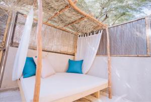 a porch swing with blue and white pillows at Sitar Ramon in Mitzpe Ramon