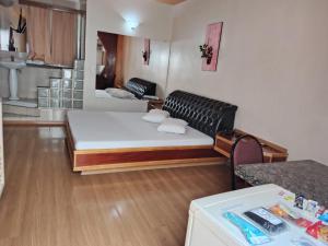 a living room with a bed and a couch at motel millenium in Betim