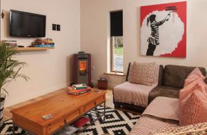a living room with a couch and a coffee table at Woodview Studio - Westport in Westport