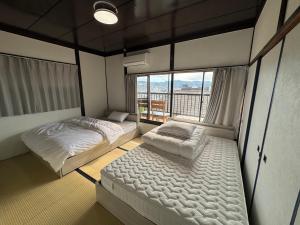 Ένα ή περισσότερα κρεβάτια σε δωμάτιο στο Private Retreat Nishizakamachi 1棟貸し切り