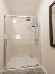 a shower with a glass door in a bathroom at Woodview Studio - Westport in Westport