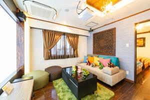a living room with a couch and a table at Hotel Balian Resort Tomei Kawasaki I.C. in Kawasaki