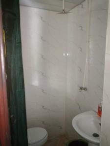 a bathroom with a toilet and a sink at Short Let Apartments in Lagos Business School Lekki Ajah in Lekki