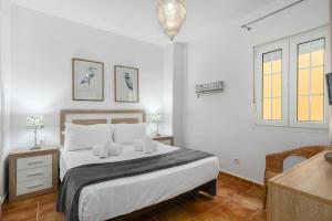 a white bedroom with a bed and a window at Playa Grande by H- Playa Punta del Moral PPHG136P111 in Isla del Moral +23 photos