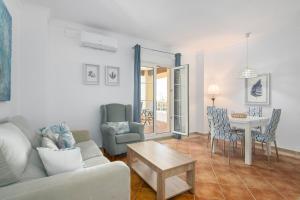 a living room with a couch and a table at Playa Grande by H- Playa Punta del Moral PPHG136P111 in Isla del Moral