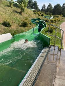 a person swimming down a water slide at Entschleunigen im Fachwerkhaus am Wald in Vielank