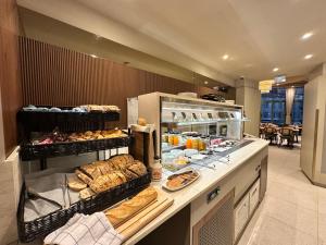 a bakery counter with a lot of bread and pastries at Hotel Ambassador, completely renovated in Nice