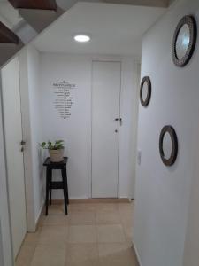 a hallway with a door and two mirrors on the wall at Entre Verde in Concepción del Uruguay +42 photos