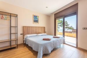 a bedroom with a bed and a large window at Villa con Infinity pool in Lloret de Mar +29 photos