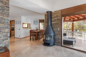 a living room with a fireplace and a dining room at Villa con Infinity pool in Lloret de Mar