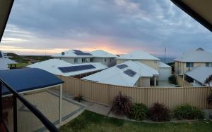 a view of a row of houses with solar panels at Sandy Toes and Sunsets Beach House in Bunbury