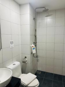 a bathroom with a shower and a toilet and a sink at Chamber Residence klcc by Golden in Kuala Lumpur