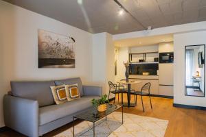 a living room with a couch and a table at BUBU Apartments By Exclusive Homes in Málaga +60 photos