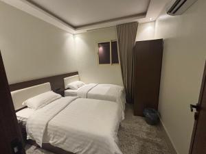 Ένα ή περισσότερα κρεβάτια σε δωμάτιο στο شالية كنف الفندقي +9 φωτογραφίες