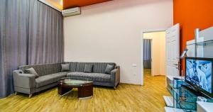 a living room with a couch and a table at VIP Apartment in Nizami street Downtown in Baku