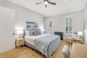 a white bedroom with a bed and a ceiling fan at CM3008: 3008 Cameron Blvd. in Isle of Palms +53 photos