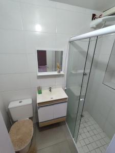a bathroom with a shower and a toilet and a sink at Pousada Confort in São Paulo +33 photos