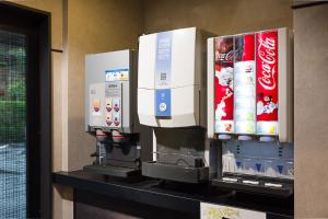 a row of cocacola machines on a shelf at hotelzekumochimune in Shizuoka