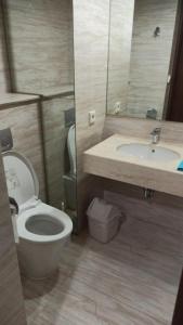 a bathroom with a toilet and a sink at Ruby Apartment #29 in Yogyakarta