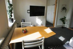 a table with two chairs and a television in a room at Id069 Englandsgade 13, 1th in Esbjerg