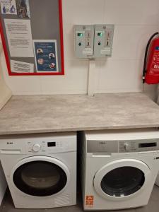 a laundry room with two washing machines and a counter at Eazy-Bed Norway's Smallest Hotel in Tromsø