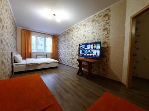 Cette chambre comprend un lit, une table, un lit et une fenêtre. dans l'établissement Однокімнатна квартира на Садовому з ліжком, à Shcherbani