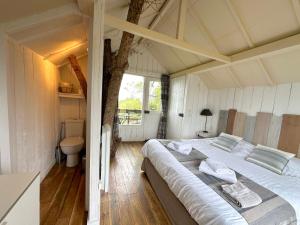 a bedroom with a bed and a tree in it at Clos de Fougères - Domaine intégral in Montoillot +25 photos