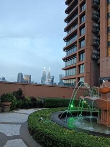 a fountain in a courtyard in front of a building at Crown Suits At Times Square in Kuala Lumpur