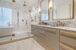 a bathroom with two sinks and a tub and a bath tub at GP58: 58 Grand Pavilion in Isle of Palms +60 photos