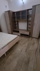 a bedroom with a bed and wooden cabinets at Пишпек плюс in Bishkek