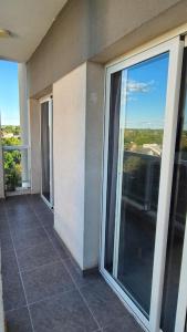 a balcony with sliding glass doors on a building at VitruApart Temporario in Resistencia