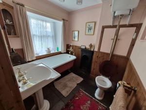 a bathroom with a white sink and a toilet at Kilfinichen Church in Kilfinchen +16 photos